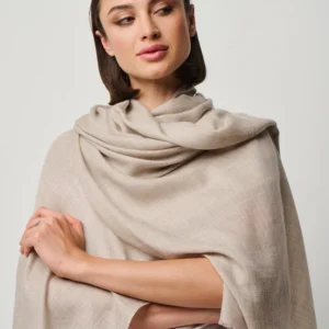 Soft cashmere blend wrap in a neutral shade featuring a cozy, oversized design for a luxurious layered look.