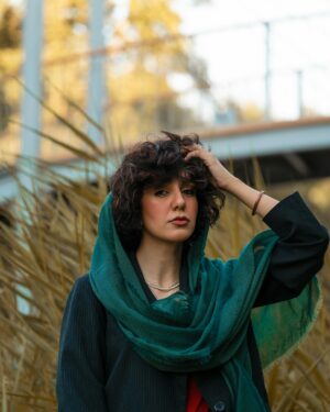 Model wearing an emerald silk scarf