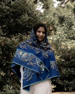 Model wearing a blue printed silk scarf