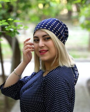 Model wearing a navy polka dot silk scarf